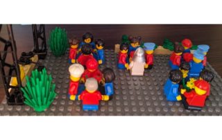 Legofiguren sitzen zusammen in Vierergruppen