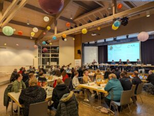 Blick durch den Saal auf die Bühne bei der Herbstvollversammlung 2024
